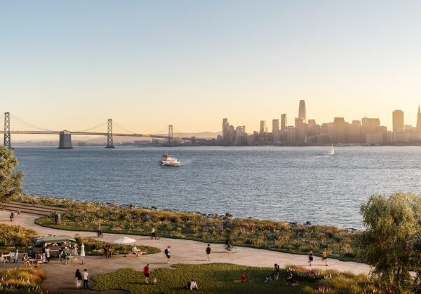 Panoramic sunset view from Treasure Island waterfront park featuring the San Francisco skyline, Bay Bridge, sailboats, and people enjoying the shoreline promenade.