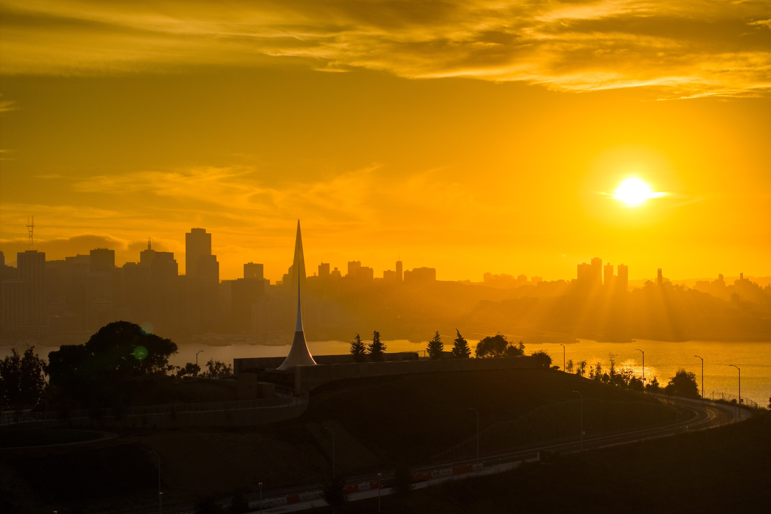 Golden sunset over the San Francisco skyline viewed from Treasure Island with the Bay glowing in warm evening light.